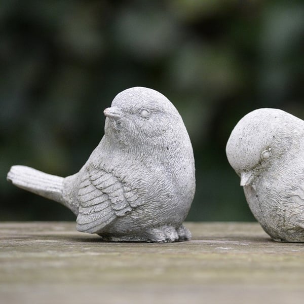 A bird sculpture appears to ignore another bird sculpture.