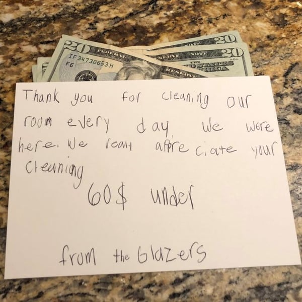 A note in a child's handwriting thanking hotel workers for cleaning a room, along with $60 USD