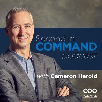 Cameron Herold crosses his arms in front of the logo for the Second In Command podcast.